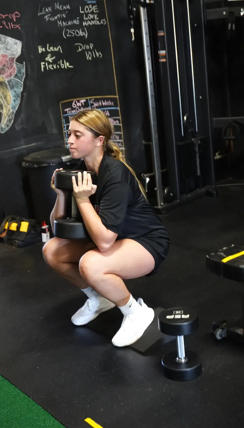 Athlete performing a coached strength exercise at TNL