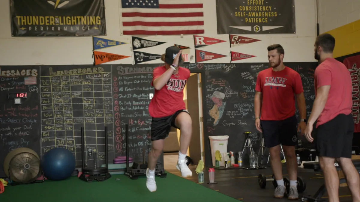 TNL athlete practicing explosive movement under coach supervision