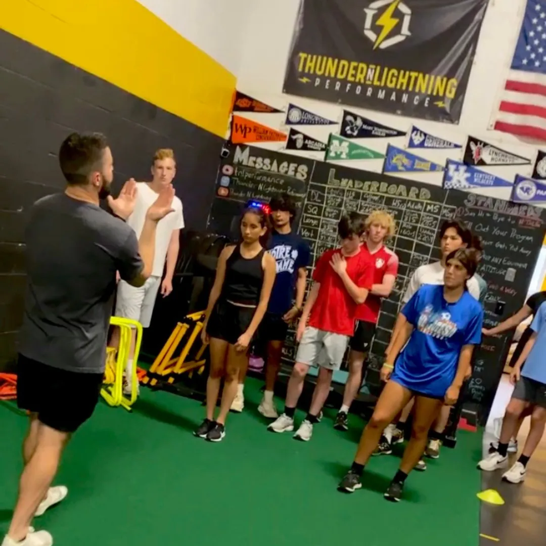 TNL performance coach teaching young athletes in a small-group session